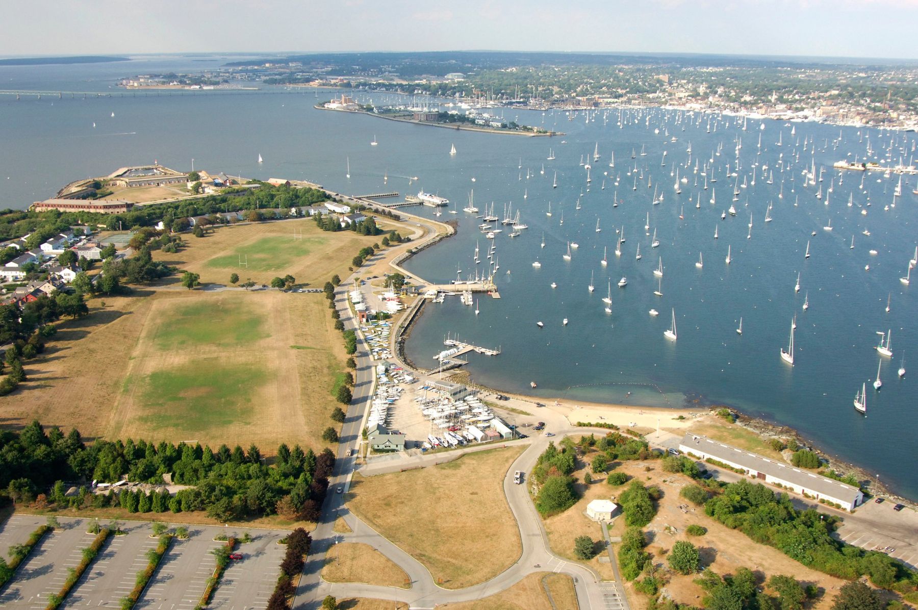 Aerial view of Sail Newport at Fort Adams State Park, with Newport Harbor full of moored boats and the city beyond
