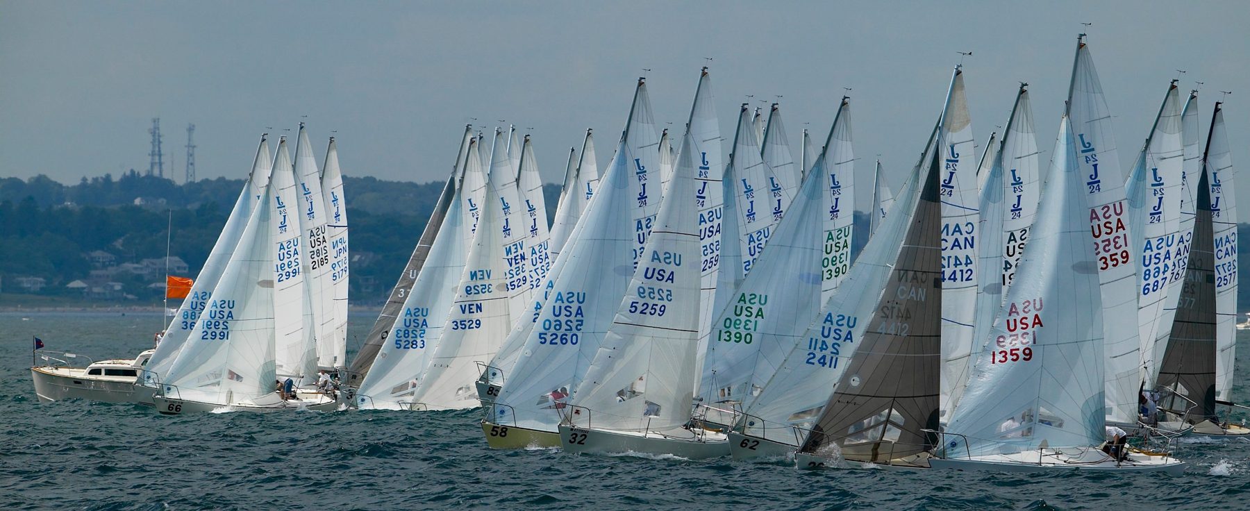 A big J/24 one-design fleet charging off the starting line